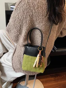 Mini color-block bucket bag with green diamond quilted texture and wooden bead charm