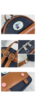 Detail of mini denim backpack showing bear embroidery and premium silver hardware buckle