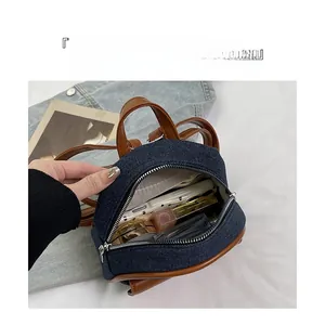 Detail view of mini denim backpack interior showing spacious storage for daily essentials