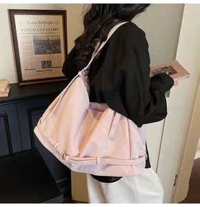 Detail of the adjustable side buckle on a dusty rose oversized soft faux suede tote bag