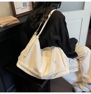 Detail of off-white large tote bag showing soft faux leather texture and shoulder strap