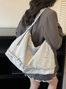 Large off-white Hobo shoulder bag worn by a model in a minimalist stylish office setting