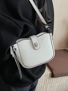 Minimalist beige faux leather square bag with brown trim and silver buckle strap