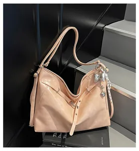 Detail of peach pink leather tote bag with silk scarf and silver butterfly charms