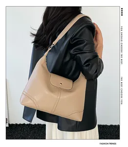 Detail view of beige minimalist large tote bag featuring wide strap and metal magnetic buckle