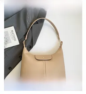 Detail view of khaki hobo bag with magnetic closure and premium stitching details