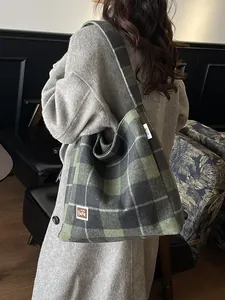 Large green and grey plaid tote bag with a woven texture and casual shoulder strap style