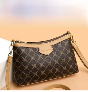 Close-up of vintage brown crossbody bag with grid pattern and gold zipper detail