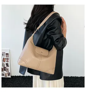 Beige oversized Hobo shoulder bag on model showing premium faux leather texture