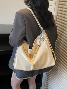 Large cream patent leather tote bag with silver butterfly charms and high-gloss finish