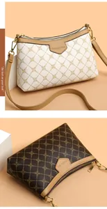 Close-up of monogram pattern shoulder bags with gold hardware and fashion brand tag