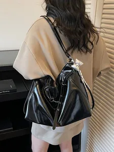 Glossy black hobo shoulder bag with silver bow charm and adjustable strap for women