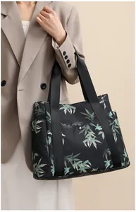 Detail of printed tote bag with bamboo patterns and side pocket for storage