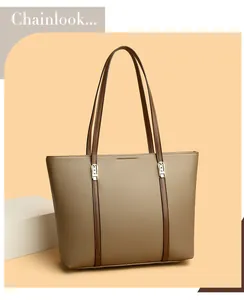 Détail du sac cabas en cuir grainé kaki avec lanières brunes et boucles dorées