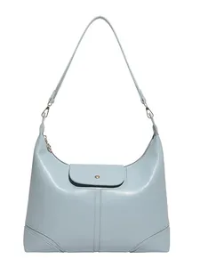 Minimalist light blue semi-circle tote bag with a golden buckle on a white background