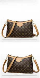 Detail view of dark brown diamond pattern shoulder bag with light brown trim and gold hardware