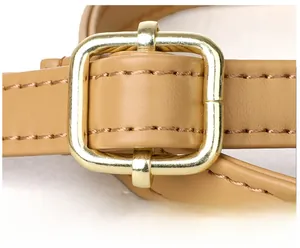 Macro detail of golden square buckle and adjustable khaki leather strap with stitching