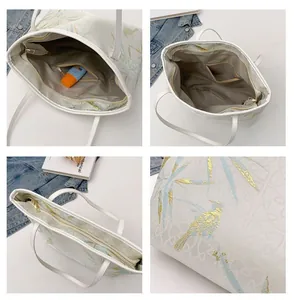 Detail view of large tote bag with bird prints, interior pockets and zipper closure