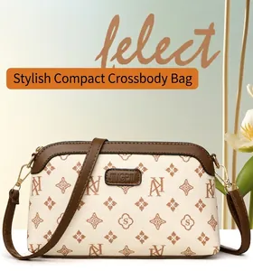 Macro view of women small crossbody bag with vintage monogram and brown leather flap