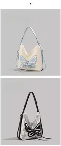 Close-up of white and silver shoulder bags with prominent butterfly pattern and ribbons