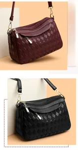 Close-up of quilted wine red and black shoulder bags with multi-zipper gold hardware