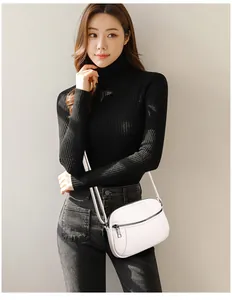 Detailed view of white litchi pattern crossbody bag with silver zipper and leather strap
