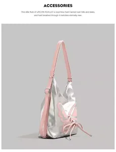 Detail view of silver mirror hobo bag featuring large pink butterfly applique and straps