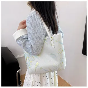 Detail of elegant Chinese style tote bag with bamboo leaves and golden bird prints