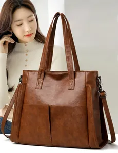 Brown soft leather tote bag with large capacity pockets and adjustable shoulder strap