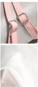 Detailed macro view of pink leather shoulder strap with adjustable silver metal buckle