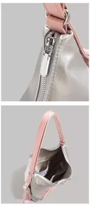 Macro view of silver and pink shoulder bag with metal zipper and interior pocket layout