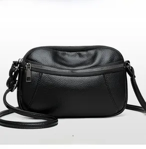 Front view of black pebble leather crossbody camera bag with silver dual zippers