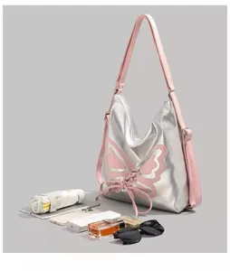 Silver butterfly bag detail showcasing capacity for umbrella, phone and cosmetics