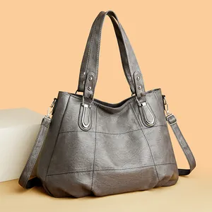 Gray vintage faux leather tote bag with large quilted stitching and silver metal hardware