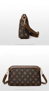 Front and back detail of a brown printed crossbody bag with metal zipper and strap