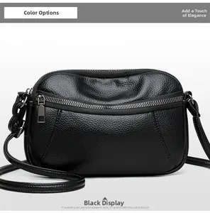 Close-up of black lychee grain leather crossbody bag with silver double zippers
