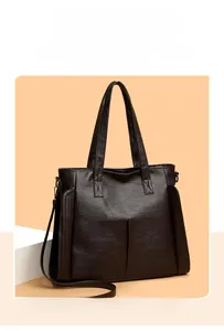 Detailed view of dark brown faux leather tote bag with fine texture and adjustable shoulder strap