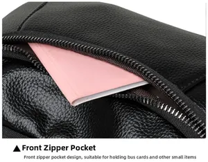 Detail of black lychee leather bag featuring a front zipper pocket for card storage
