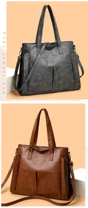 Detail view of large soft leather tote bag with lychee texture and detachable shoulder strap