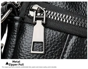 Detailed macro of smooth silver zipper hardware on black lychee grain leather bag