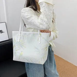 Detail of New Chinese style tote bag with blue bamboo leaves and golden bird patterns