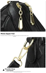 Detail of high-gloss gold zippers and metal hardware on black lychee texture bag