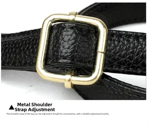 Detail of adjustable black litchi grain leather strap with polished gold buckle
