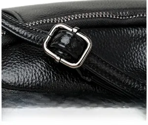 Close-up of pebble grain leather shoulder strap with adjustable silver metal buckle detail