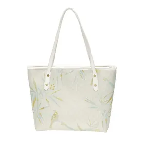 Minimalist white tote bag with elegant blue bamboo and bird patterns for women