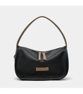 Detail of lychee pattern leather and two-way zipper on black underarm bag
