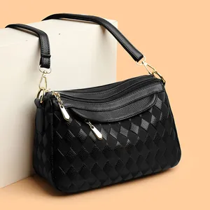 Elegant black quilted shoulder bag for women with gold hardware and multi-zipper design