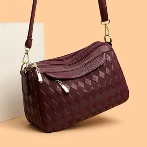 Classic burgundy leather crossbody bag for women with rhombus quilting and gold zippers