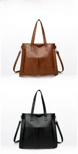 Detail view of large capacity tote bag in brown and black with soft lychee texture