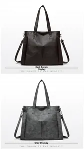 Detail view of large soft leather tote bags in dark brown and grey with adjustable straps